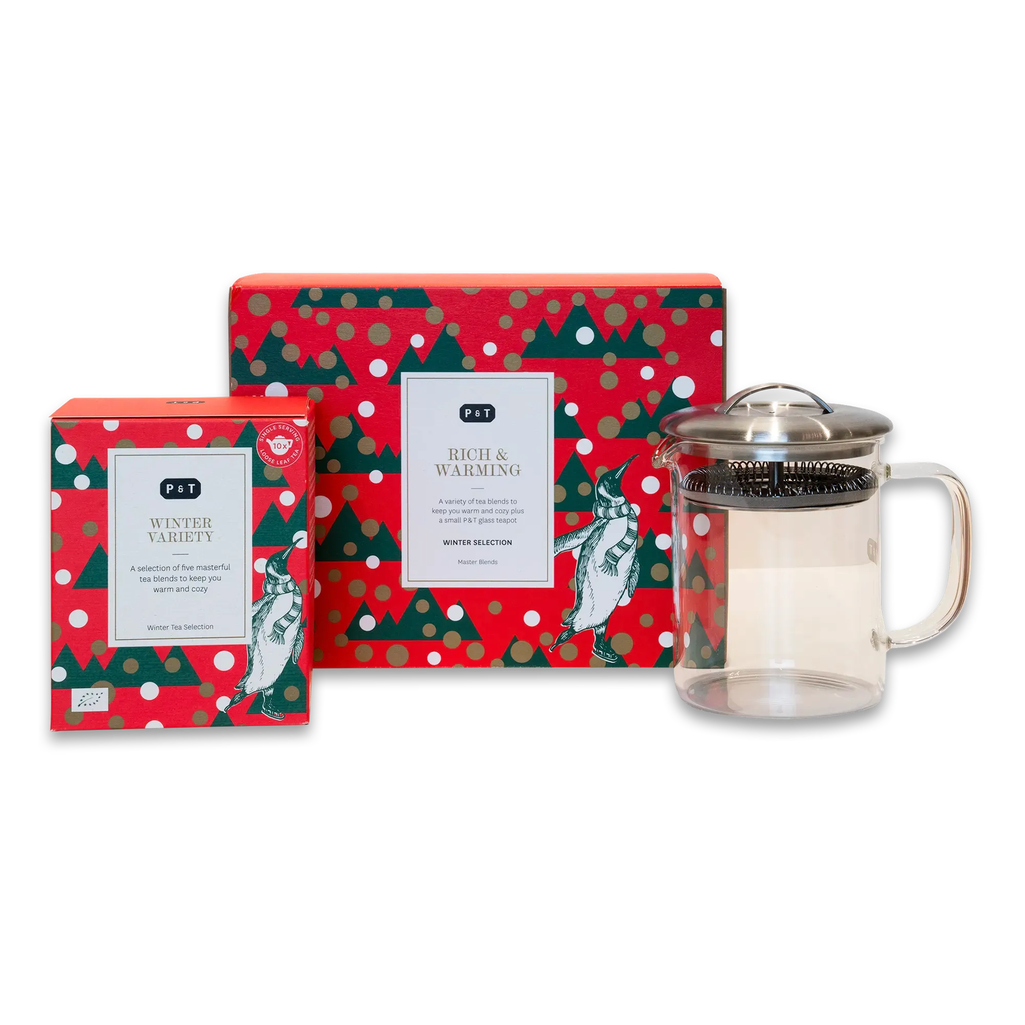 Rot und grün dekorierte Weihnachtstee-Packungen mit Pinguinen und Teekanne mit Infuser.
